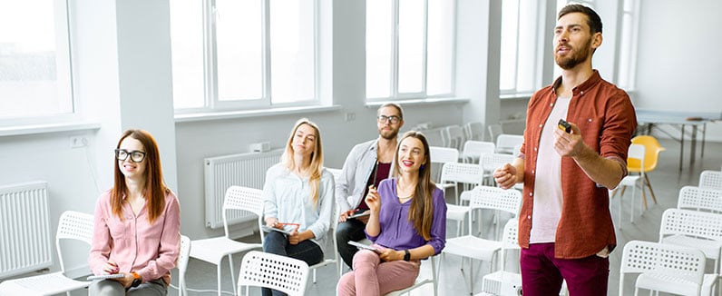 man teaching adults