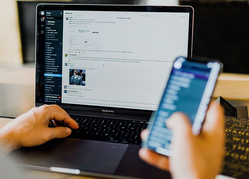 man using phone and laptop