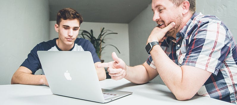 men talking using laptop