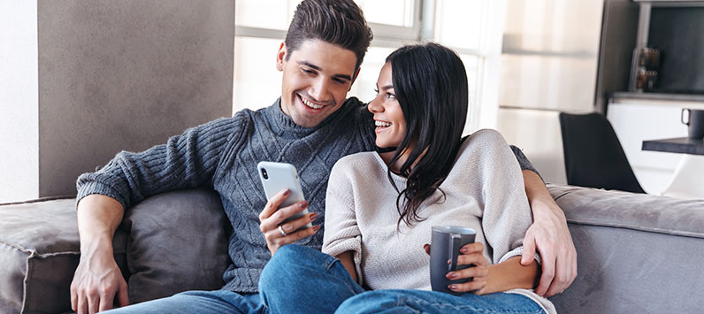 smiling couple checking phone