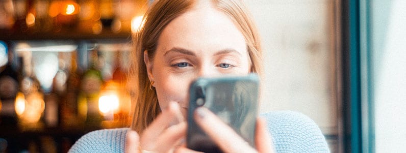 happy woman eyes staring at phone