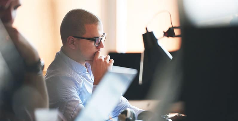 man in an office in thinking pose