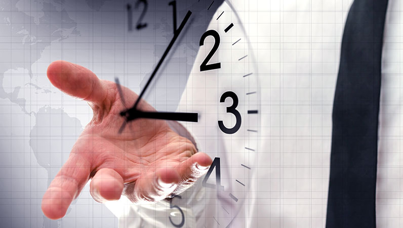 mans hand behind a transparent clock