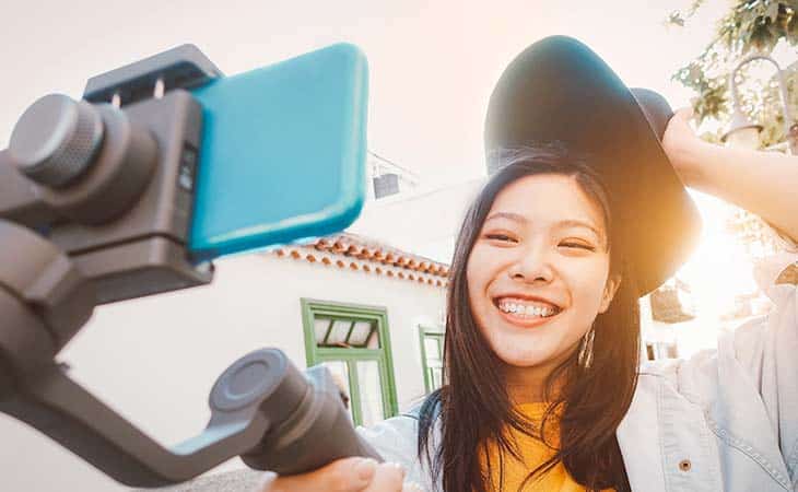 woman smiling looking phone video