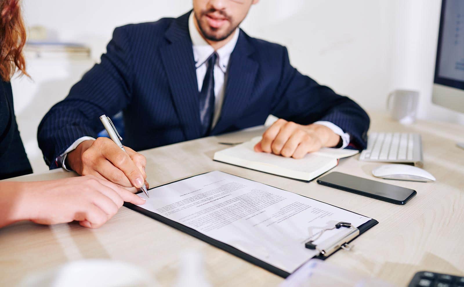 a man and a woman signing a contract