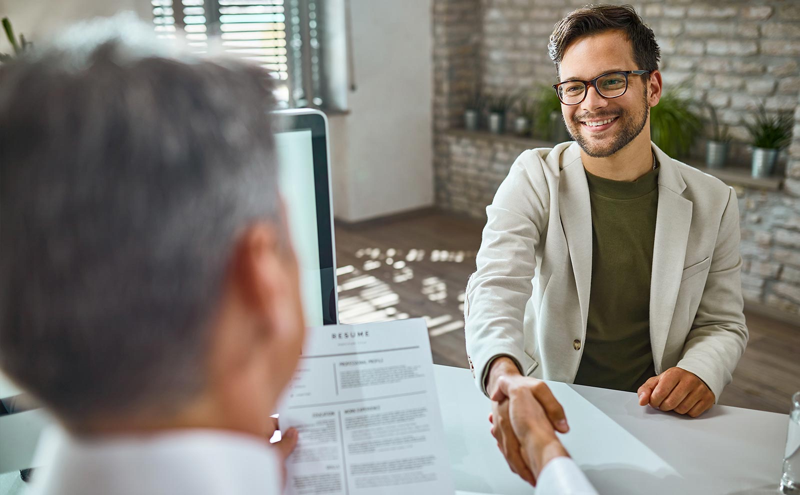 employer and employee shaking hands