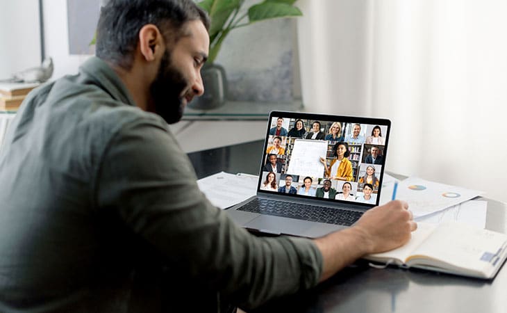 man having a meeting on his laptop