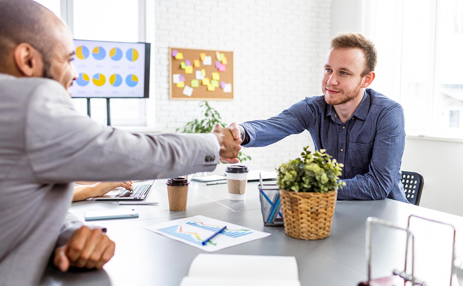 two men shaking negotiating and shaking hands