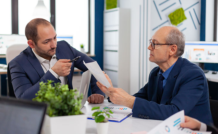 two serious men negotiating in an interview