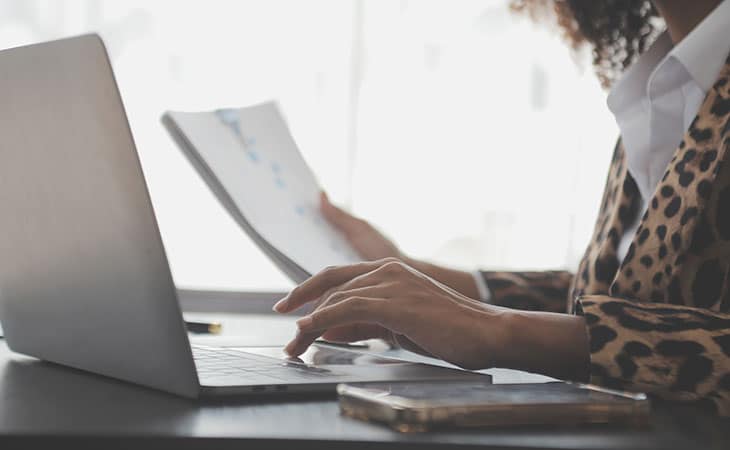 women working with papers and laptop