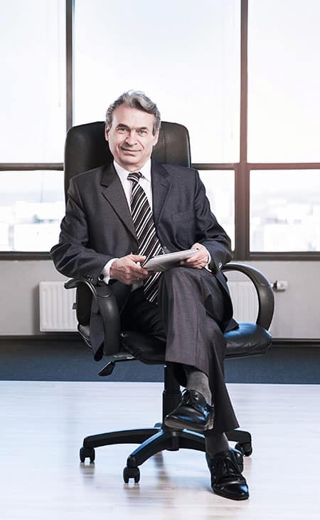 Job Descriptions For Executives (With Template &Amp; Examples) Evinex Corporation | Staffing Agency executive sitting on a chair