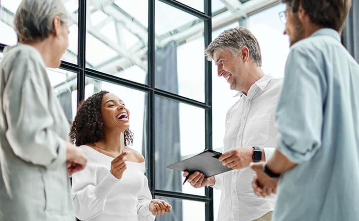 group of people smiling and working together