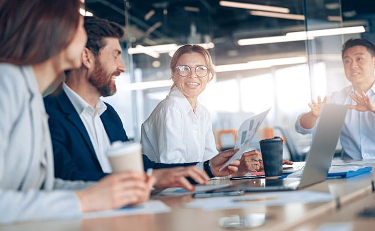 Job Descriptions For Executives (With Template &Amp; Examples) Evinex Corporation | Staffing Agency group of people working and having coffee