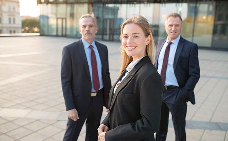 Job Descriptions For Executives (With Template &Amp; Examples) Evinex Corporation | Staffing Agency team smiling on the street