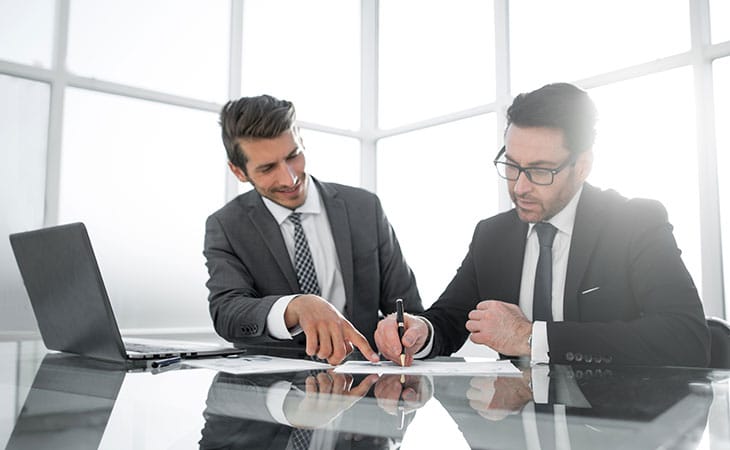 Job Descriptions For Executives (With Template &Amp; Examples) Evinex Corporation | Staffing Agency two businessmen working