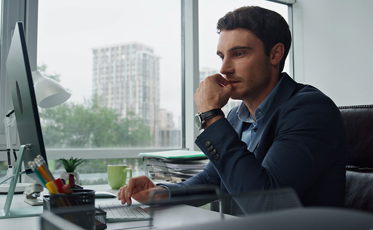 Program Manager Job Description: Essential Skills Guide Evinex Corporation | Staffing Agency man-thniking-hand-computer