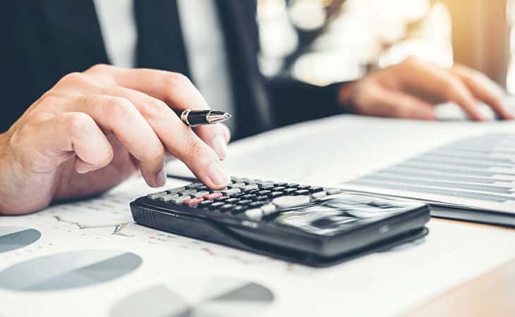 100+ Interview Questions For Executives With Sample Answers Evinex Corporation | Staffing Agency man using a calculator