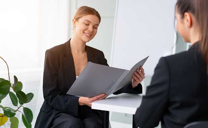 100+ Interview Questions For Executives With Sample Answers Evinex Corporation | Staffing Agency two women in a job interview