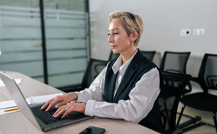100+ Interview Questions For Executives With Sample Answers Evinex Corporation | Staffing Agency woman working with her laptop