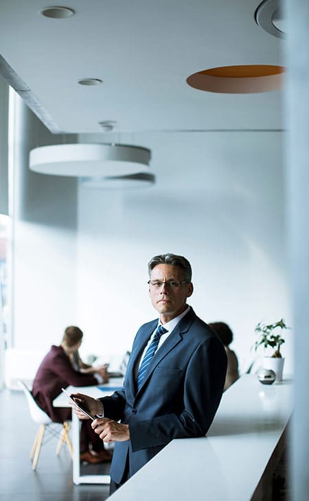 businessman-looks-camera-office