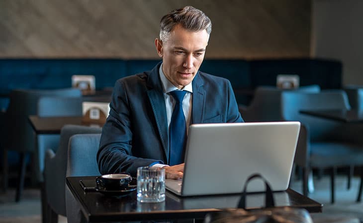 100+ Director Interview Questions - What To Ask + Answers Evinex Corporation | Staffing Agency man-cafe-looking-laptop-table