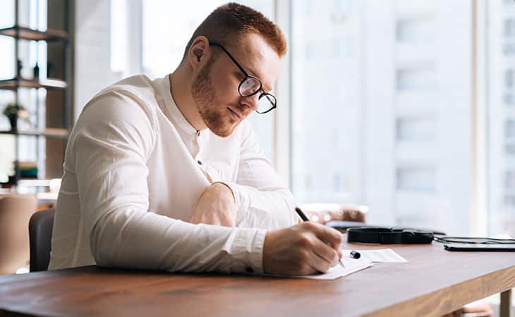 man-glasses-writing-pen