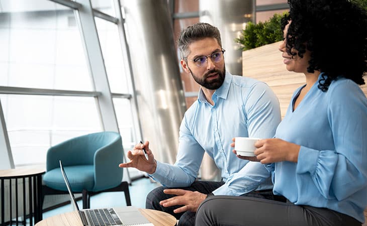 man-talking-woman-laptop