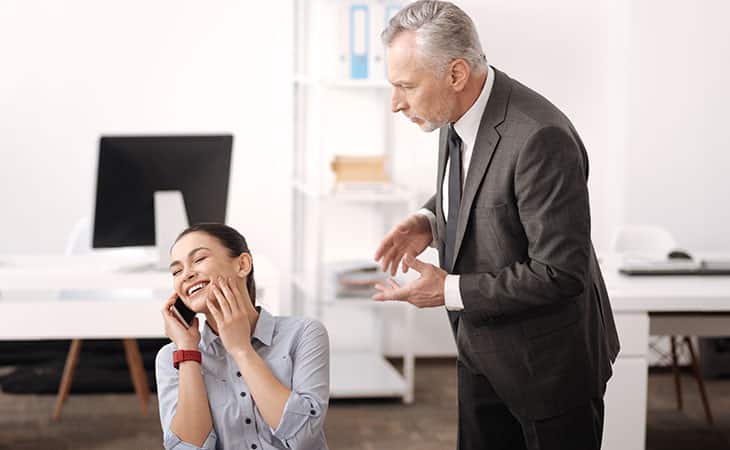 man-talking-woman-phone-office