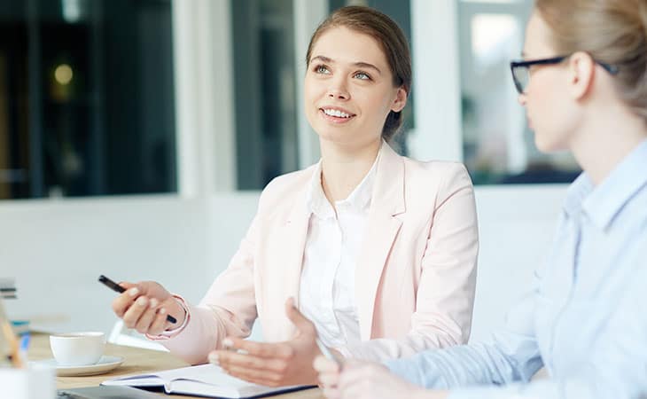 100+ Director Interview Questions - What To Ask + Answers Evinex Corporation | Staffing Agency two-woman-explaining-office