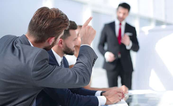 100+ Program Manager Interview Questions To Find Top Talent Evinex Corporation | Staffing Agency man-asking-question-potining-meeting