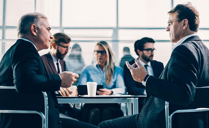 100+ Program Manager Interview Questions To Find Top Talent Evinex Corporation | Staffing Agency people-meeting-executives-table