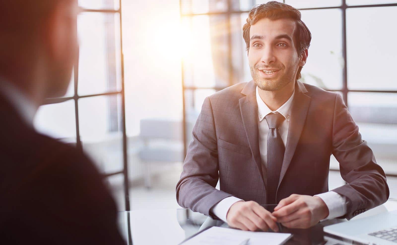smiling-man-suit-talking