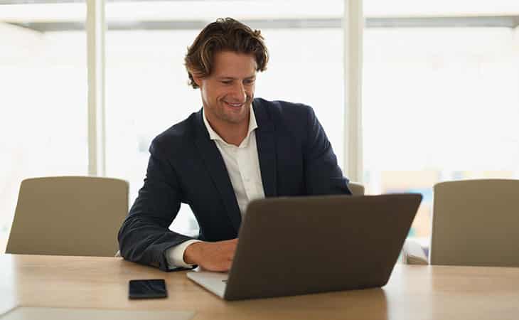 smiling-man-using-computer