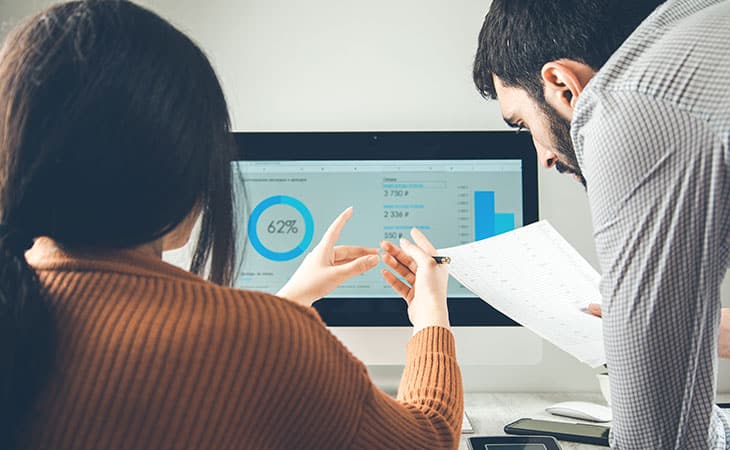 100+ Program Manager Interview Questions To Find Top Talent Evinex Corporation | Staffing Agency woman-explains-data-man-papers