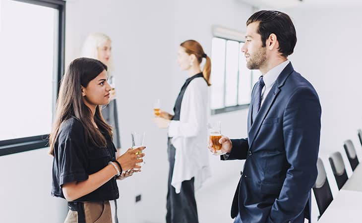 people talking in a meeting in an office having drinks