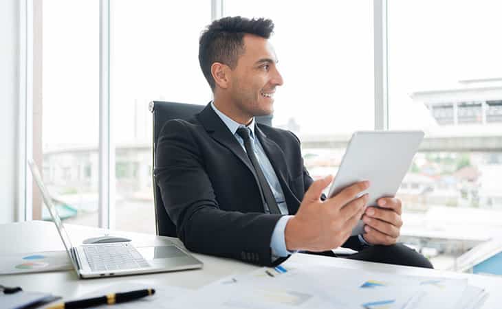 100+ Interview Questions To Identify Top Product Owners Evinex Corporation | Staffing Agency smiling-man-holding-tablet