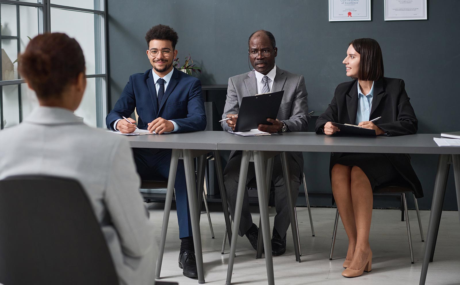three-people-interviewing-woman
