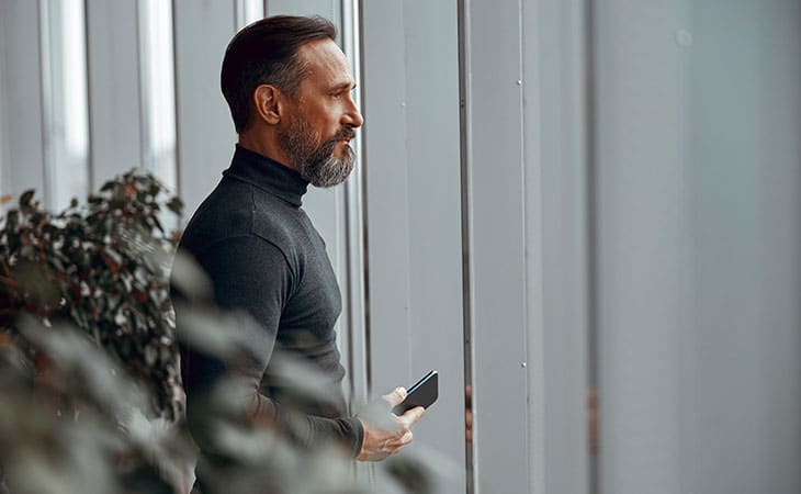 Mastering Interpersonal Skills: Your Guide To Success Evinex Corporation | Staffing Agency a thoughtful man with his phone in his hand