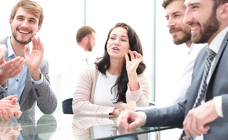 Mastering Interpersonal Skills: Your Guide To Success Evinex Corporation | Staffing Agency a woman making gestures and talking with people in an office