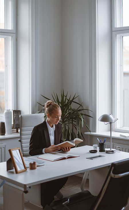 Mastering Interpersonal Skills: Your Guide To Success Evinex Corporation | Staffing Agency a woman reading a book in an office