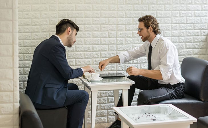 two men having a conversation at a table