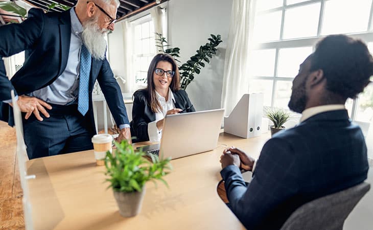 How To Hire An Employee: A Step-By-Step Complete Guide Evinex Corporation | Staffing Agency two people interviewing a man in a suit