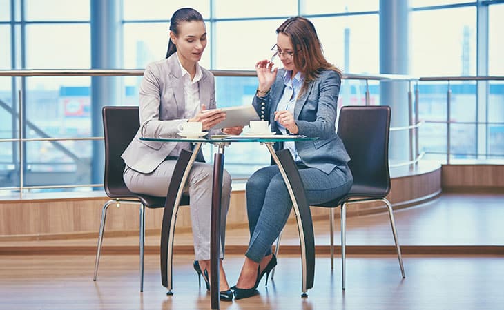 How To Hire An Employee: A Step-By-Step Complete Guide Evinex Corporation | Staffing Agency two women talking at the glass table