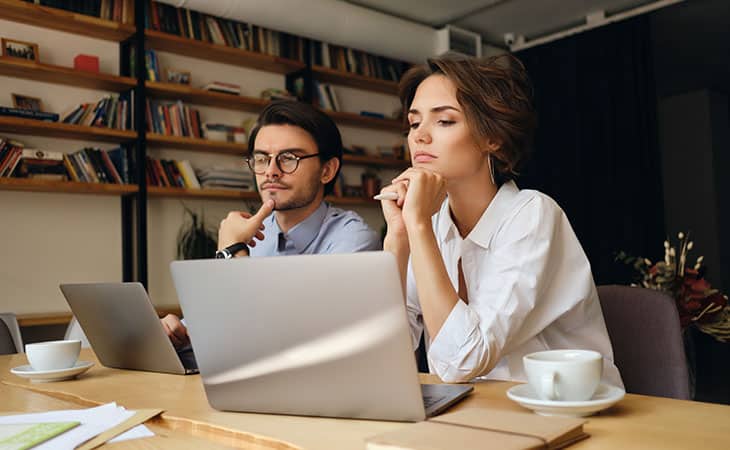 100+ Essential Business Analyst Interview Questions Evinex Corporation | Staffing Agency couple-thinking-using-laptop