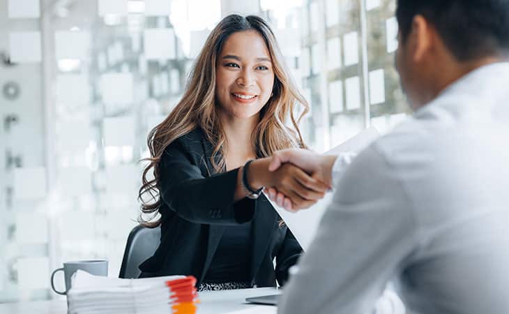 100+ Essential Business Analyst Interview Questions Evinex Corporation | Staffing Agency happy-woman-handshake-interviewer