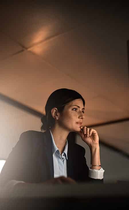 How To Hire An Employee: A Step-By-Step Complete Guide Evinex Corporation | Staffing Agency woman with her hand in her chin looking at a computer