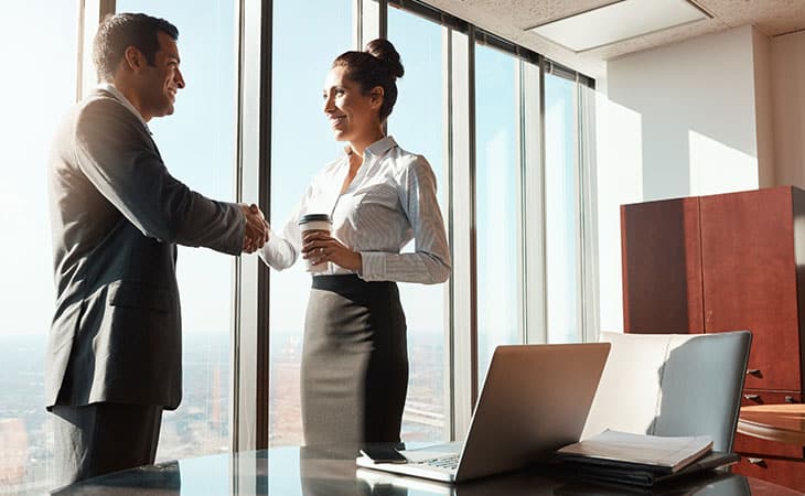 Sales Manager Job Description: Attract And Hire Top Talent Evinex Corporation | Staffing Agency a man and a woman shaking hands