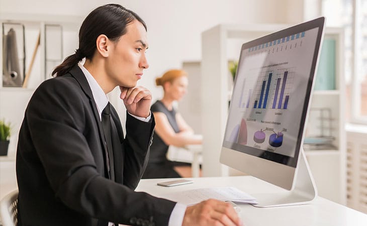 Sales Manager Job Description: Attract And Hire Top Talent Evinex Corporation | Staffing Agency a thoughtful businessman looking at his computer