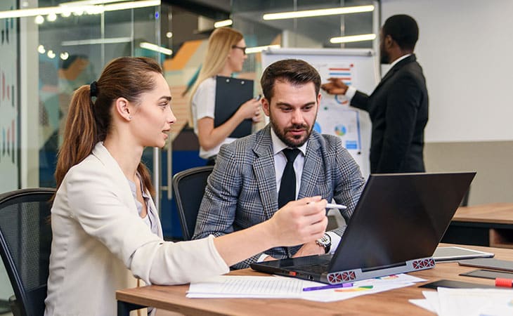 100+ Interview Questions For The Perfect Executive Assistant Evinex Corporation | Staffing Agency people-talking-office-laptop-papers