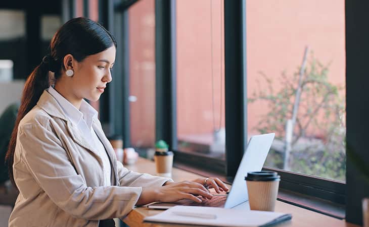 100+ Interview Questions For The Perfect Executive Assistant Evinex Corporation | Staffing Agency woman-working-laptop-window